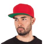 Klassische Snapback Cap in Rot mit grünem Schirm, getragen von einem Mann – ideal für individuelle Bedruckung